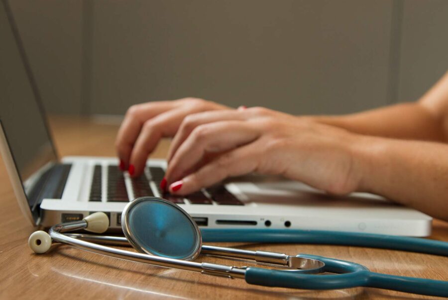 for physicians, female medical professional typing on a laptop, triad clinical trials