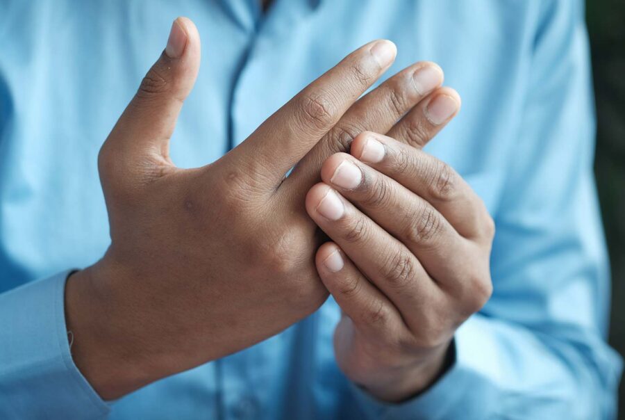 man holding painful wrist, about gout
