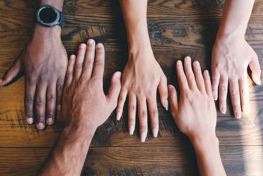 hands of people with different diversity on table, diversity in clinical trials recruitment for sponsors