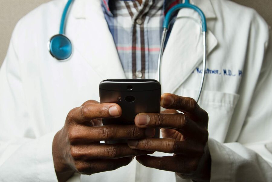 doctor using his mobile phone, reasons to participate in a clinical trial